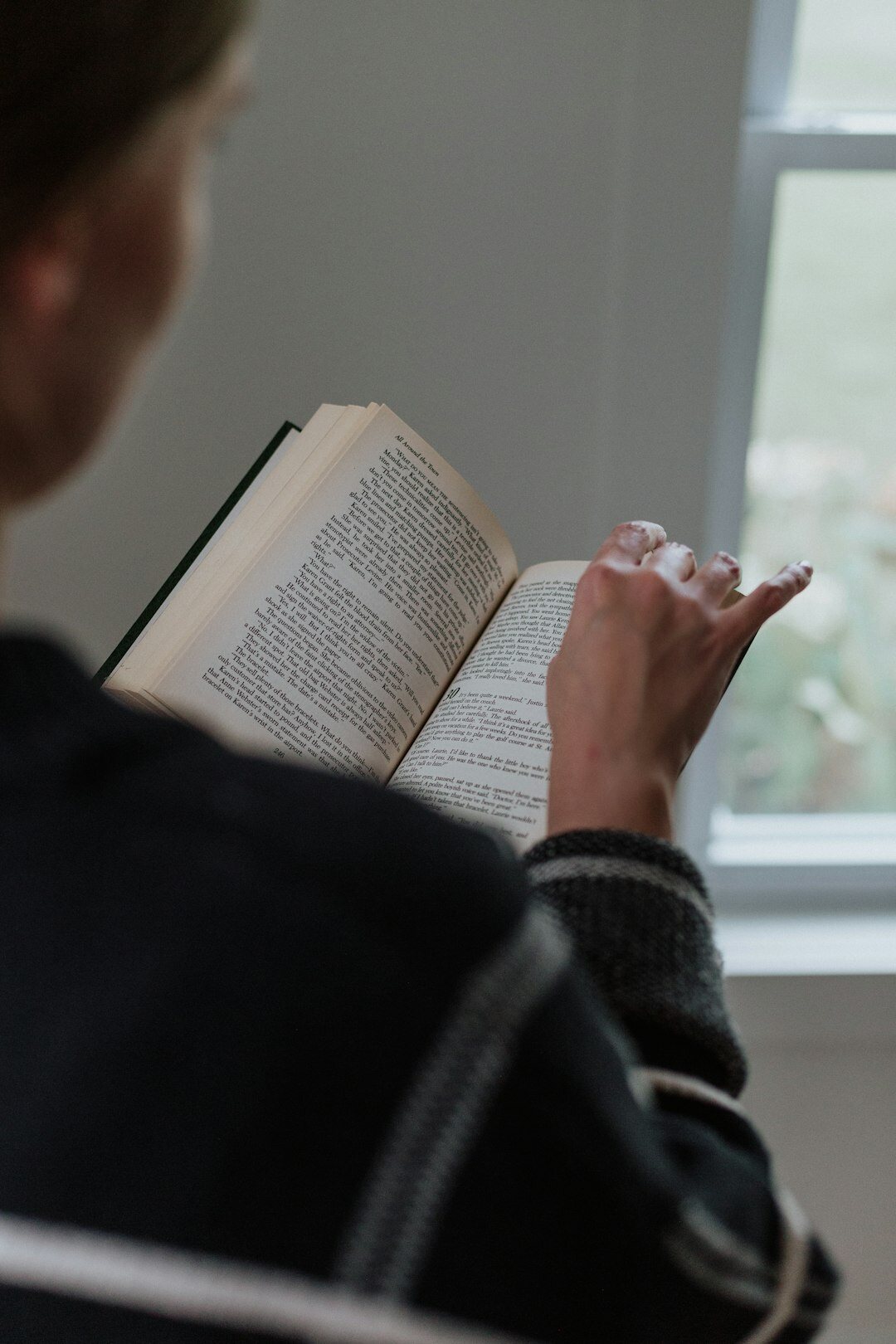 person reading thriller book