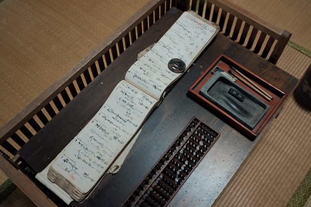 Wooden desk with rotary phone, notepad and pen
