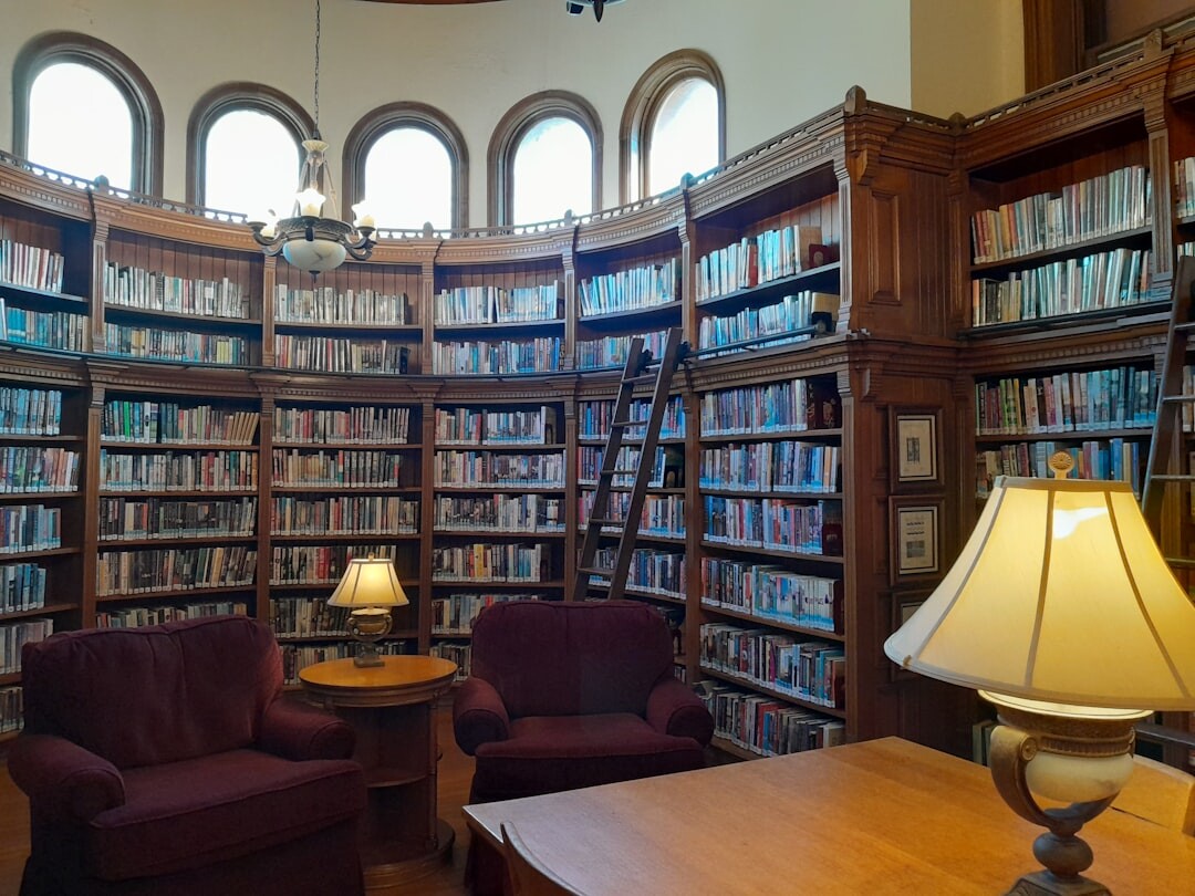 Cozy old library with tall wooden bookshelves